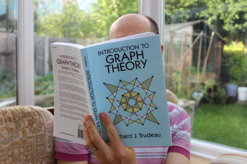 Author reading 'Introduction to Graph theory'